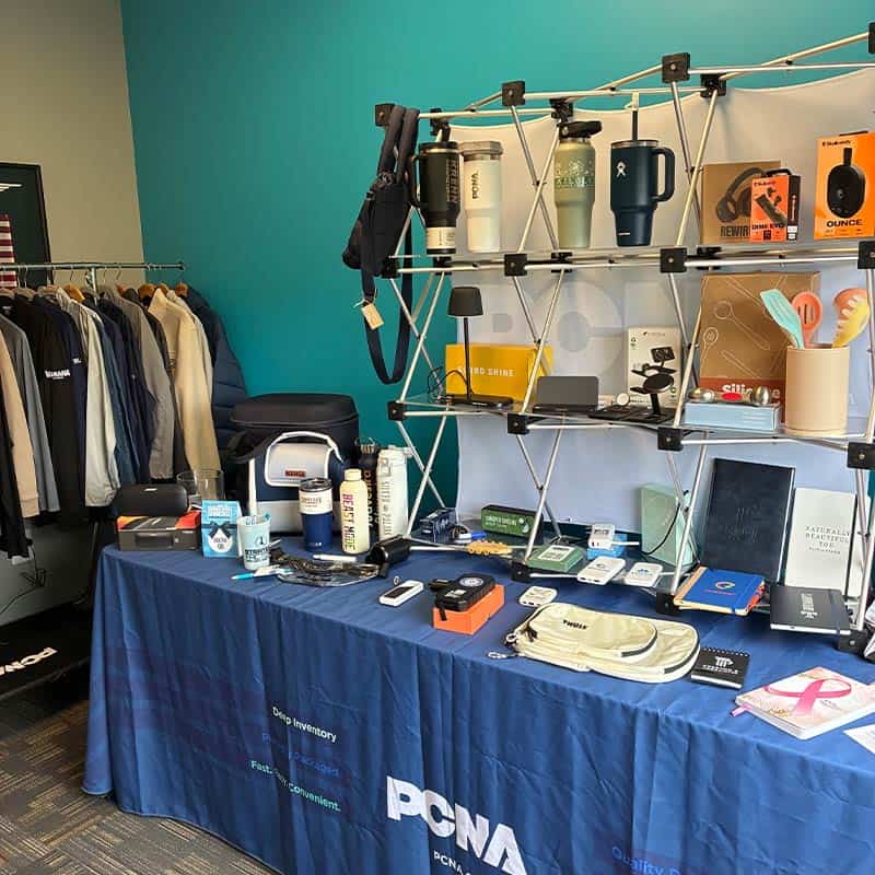strategic factory corporate gifting showcase booth with trending promotional products and branded apparel displayed