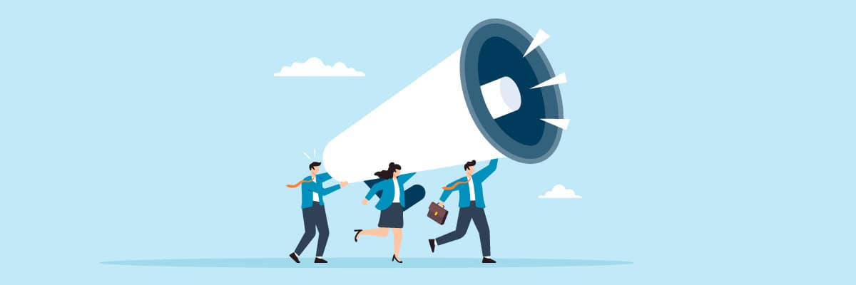 three business people carrying a large megaphone to make an announcement