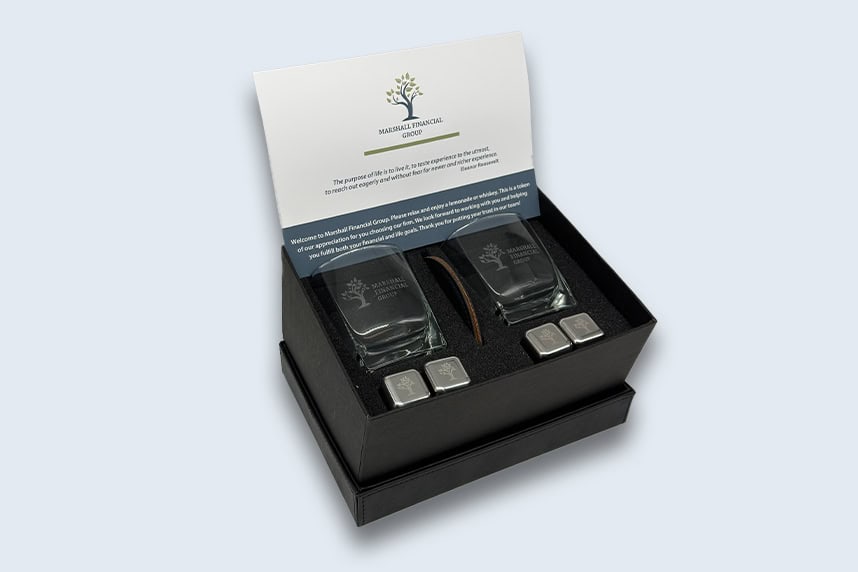 Custom branded gift box with branded rocks glasses and cold stones for Marshall Financial Group made by Strategic Factory.