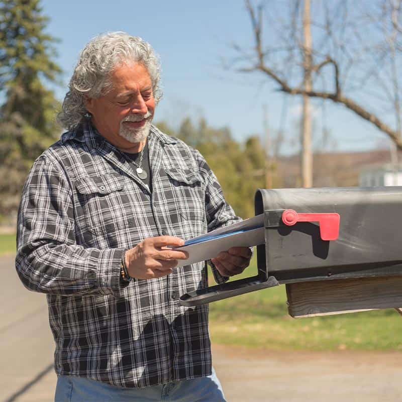 man getting mail from mailbox