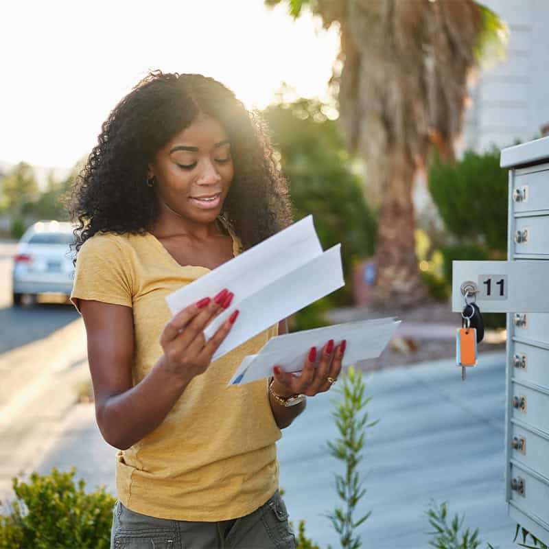 woman reading mail in mailbox