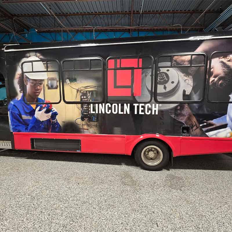 Lincoln Tech vinyl truck wrap made by Strategic Factory, with blue collar workers on the truck.