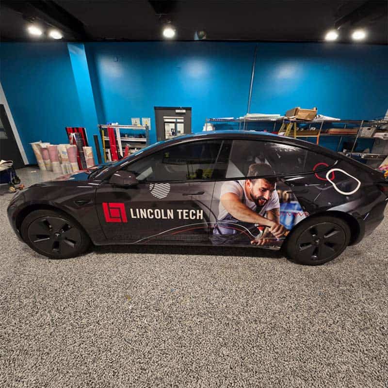 Lincoln Tech vehicle wrap with blue collar worker on the side made by Strategic Factory.