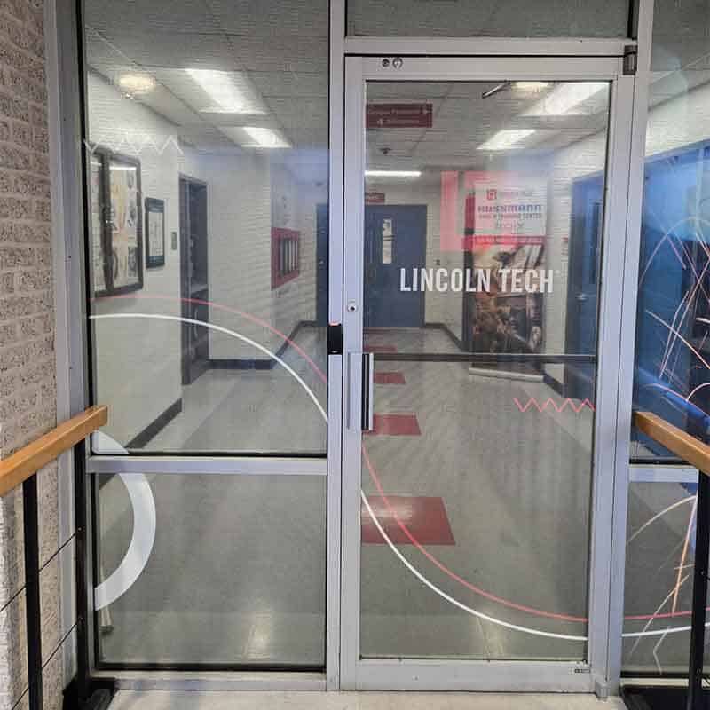 Branded glass door graphics at Lincoln Tech made by Strategic Factory.