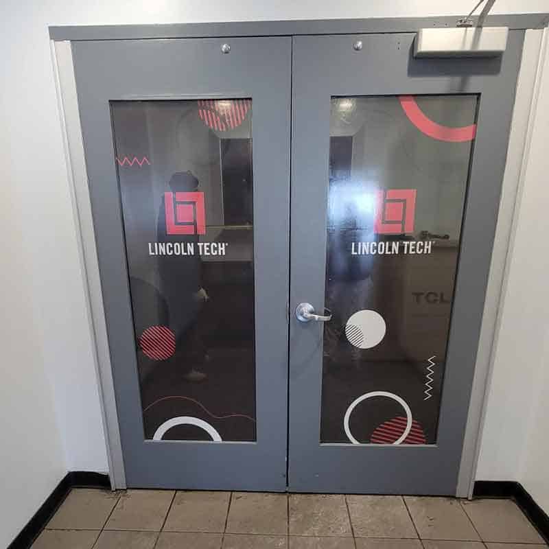 Vinyl door wrap at Lincoln Tech made by Strategic Factory.