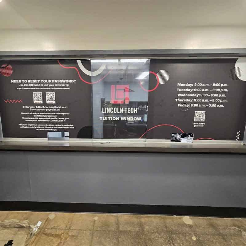 Window vinyl graphics at Lincoln Tech tuition window made by Strategic Factory.