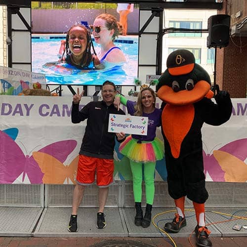Strategic Factory supports community involvement and staff pose with the Oriole's mascot at Horizon Day Camp's fundraising event