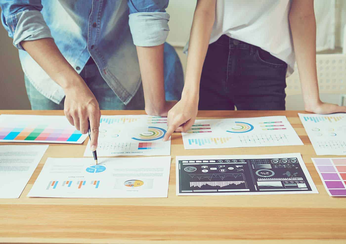 Brand strategy planning session with a team collaborating over marketing materials and design concepts