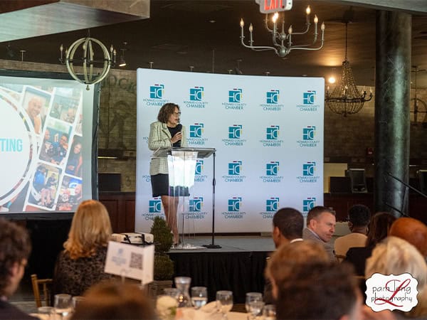 Executive Committee Chair, Cheryl Brown, presents on stage at the Howard County Chamber of Commerce Annual Meeting.