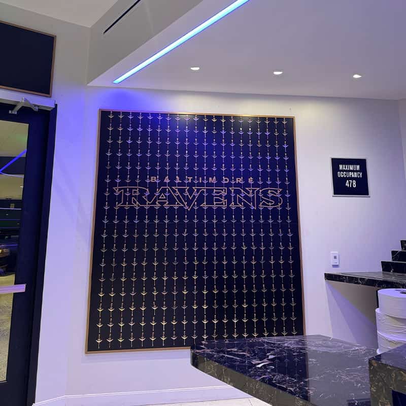 custom sign made from a wall of keys, dye cut metal, and dimensional letters for newly renovated suites in the Baltimore Ravens M&T Bank Stadium