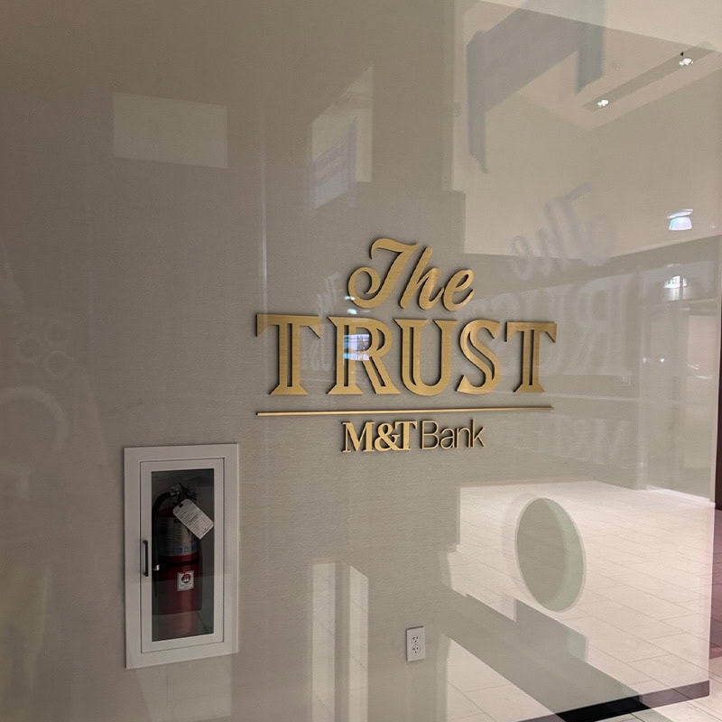 glossy marble wall with gold metal custom cut letters sign