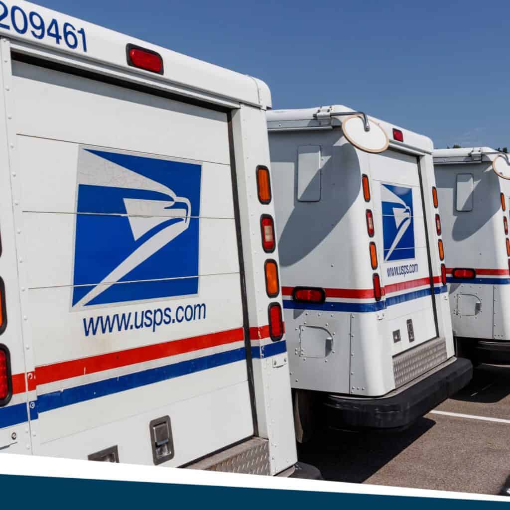 Three USPS trucks parked.