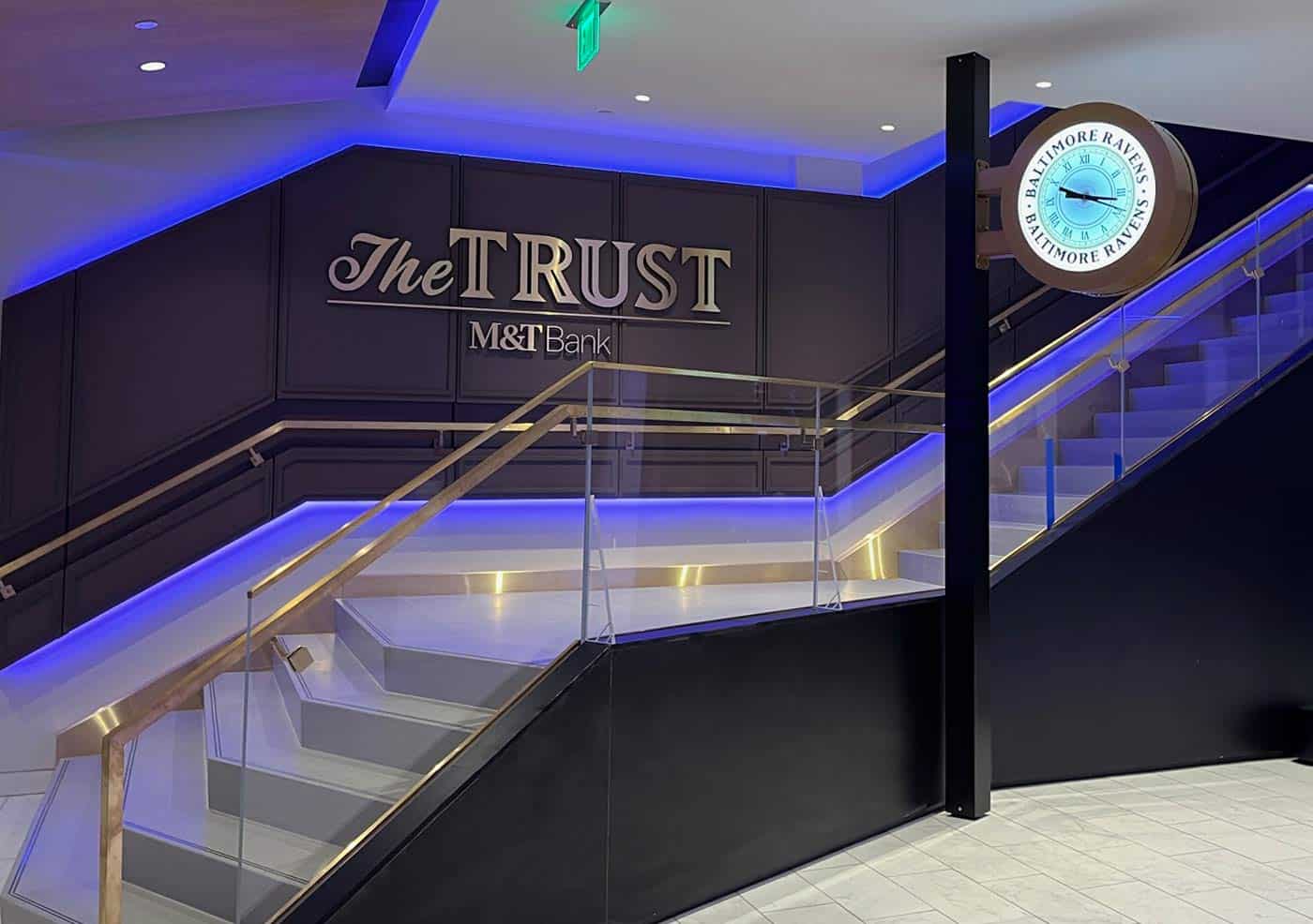 Interior view of The Trust, M&T Bank club area at M&T Bank Stadium with illuminated Baltimore Ravens clock.